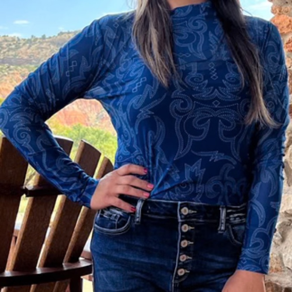 This top is on fire! Blue mesh top with unique white boot stitch design.